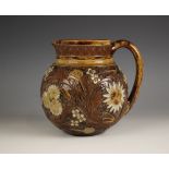 A Robert Wallace for Martin Brothers jug circa 1885, the stoneware globular jug with carved