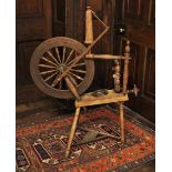 * A 19th century stained wood spinning wheel, the 50cm diameter sixteen spindle wheel, upon turned