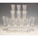 Twelve ale flutes, of typical conical form, each with basal faceting extending to a faceted stem, on