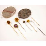 A late 19th century citrine stick pin, the oval cut citrine within a yellow metal six claw setting