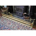 * A 19th century pierced brass fender, straight front with spherical finials, 162cm wide, a copper