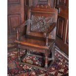 * A 17th century oak Wainscot chair, the shaped top rail with three roundels over a back panel