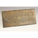 A wall mounted brass name plate, early 20th century, the rectangular sign with cast lettering 'R.