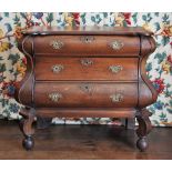 * A Dutch oak commode/chest of drawers, 18th century, of bombe form, the shaped and rounded top of