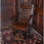 * A 17th century oak Wainscot chair, the architectural top rail over a back panel centred with an