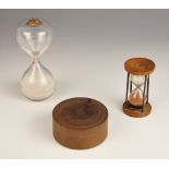 A 19th century glass sand timer, of typical form, with cork stopper, 12cm high, a second smaller