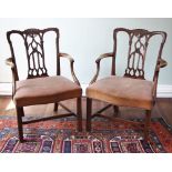 * A pair of George III mahogany elbow chairs, each with an interlaced splat back, extending to out