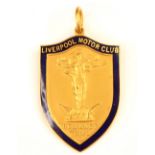 A 9ct yellow gold ‘Liverpool Motor Club’ medal, the shield shaped medal with blue enamel border