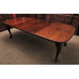 * A Victorian mahogany extending dining table, the rectangular moulded top with rounded corners upon
