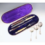 A pair of silver coloured apostle spoons, the spoons with plain polished bowls with twisted stem and