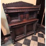 * A 17th century and later carved oak court cupboard, with a rear arched and nulled gallery,