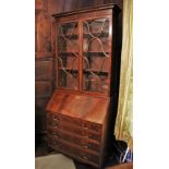 * A 19th century mahogany bureau/bookcase, the simulated dentil cornice above a pair of ogee