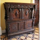 * A 17th century and later carved oak Flemish livery/hall cupboard, the three panel parquetry top