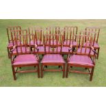 * A set of twelve George III mahogany dining chairs, each with quatre lobed rail back, over a padded