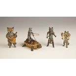 A group of three white metal painted cat models, 20th century, to include a model of a cat holding