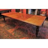 * A 19th century mahogany dining table, the rectangular moulded top with rounded corners, upon