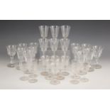 A selection of drinking glasses, to included a set of fourteen wine glasses, each with faceted