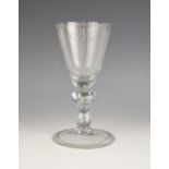 A heavy baluster wine glass or goblet, 18th century, the large funnel bowl with tear drop base on