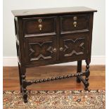 * A Jacobean revival oak side cabinet, circa 1920, formed as two drawers over two cupboard doors,