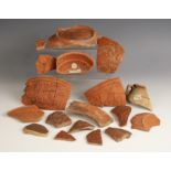 A collection of Roman Samian Ware pottery fragments, to include a fragment bearing Royal
