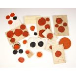 A large collection of wax seals, the red and black seals depicting various crests, predominately