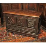 * A 17th century oak coffer, later converted to a fall front, the rectangular moulded top above