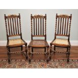 * A trio of Carolean style oak dining chairs, early 20th century, each with a carved coronet and