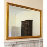 * A Victorian style gilt painted wall mirror, the rectangular ogee moulded frame enclosing a