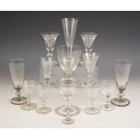 A pair of heavy glass ale flutes, each with annular knop, unpolished pontils, each 14.5cm high, with