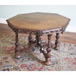 * A 19th century carved oak centre table, the octagonal top with a gadrooned edge and carved foliate