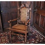 * A Carolean style oak open armchair, 19th century, the naturalistic leaf carved crest above a