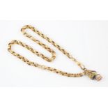 An early 20th century yellow metal guard chain, the flat trace link chain with swivel fob, the
