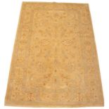 A Pakistan Garous design wool rug, in autumnal colourways, the central scrolling foliate field