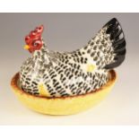 An Emma Bridgewater egg holder, 21st century, modelled as a chicken sitting on a nest, 19cm high
