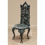 A Victorian Coalbrookdale style cast iron garden/patio chair, the openwork architectural high back