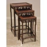 A nest of three Chinese rosewood tables, 20th century, of rectangular form, with a carved vinery