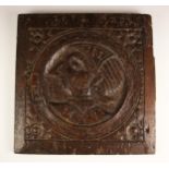 A 16th/17th oak panel, carved with a Romayne medallion within flowerhead spandrels, 33cm Sq
