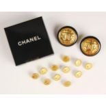 A pair of Chanel costume earrings, the circular earrings with black border encompassing gold