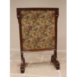 A Victorian walnut framed country house fire screen, late 19th century, the angular frame