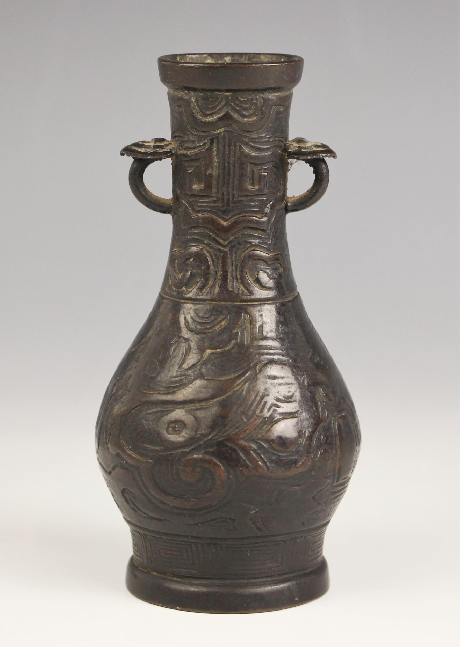 A Chinese Archaic style bronze vase, in arrow type form, the swollen body leading to a tapered