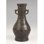 A Chinese Archaic style bronze vase, in arrow type form, the swollen body leading to a tapered