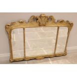 A George II style giltwood and gesso overmantel triple plate wall mirror, the Prince of Wales