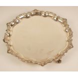A silver salver, Francis Howard Ltd, Sheffield 1975, of circular form with pie crust and shell