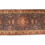 A Persian pattern wool runner, in red, blue, green and ivory colourways, the three central lozenge