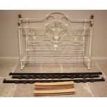 A Victorian style painted iron bed, the head and foot boards of openwork, scroll and roundel form,