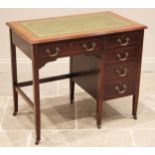 An Edwardian mahogany writing desk, the rectangular moulded top inset with a green leather and