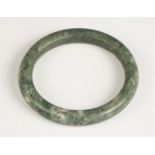 A Chinese polished Jade bangle, of plain polished spherical form, 7.5cm wide overall