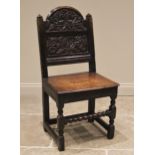 A joined oak back stool, late 17th/early 18th century, the break arch back rest carved with fruit