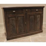 An Edwardian walnut side cupboard, the moulded top with a dentil frieze over three drawers and a