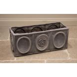 A lead planter trough, of rectangular form, cast in relief with oval panels punctuated with a